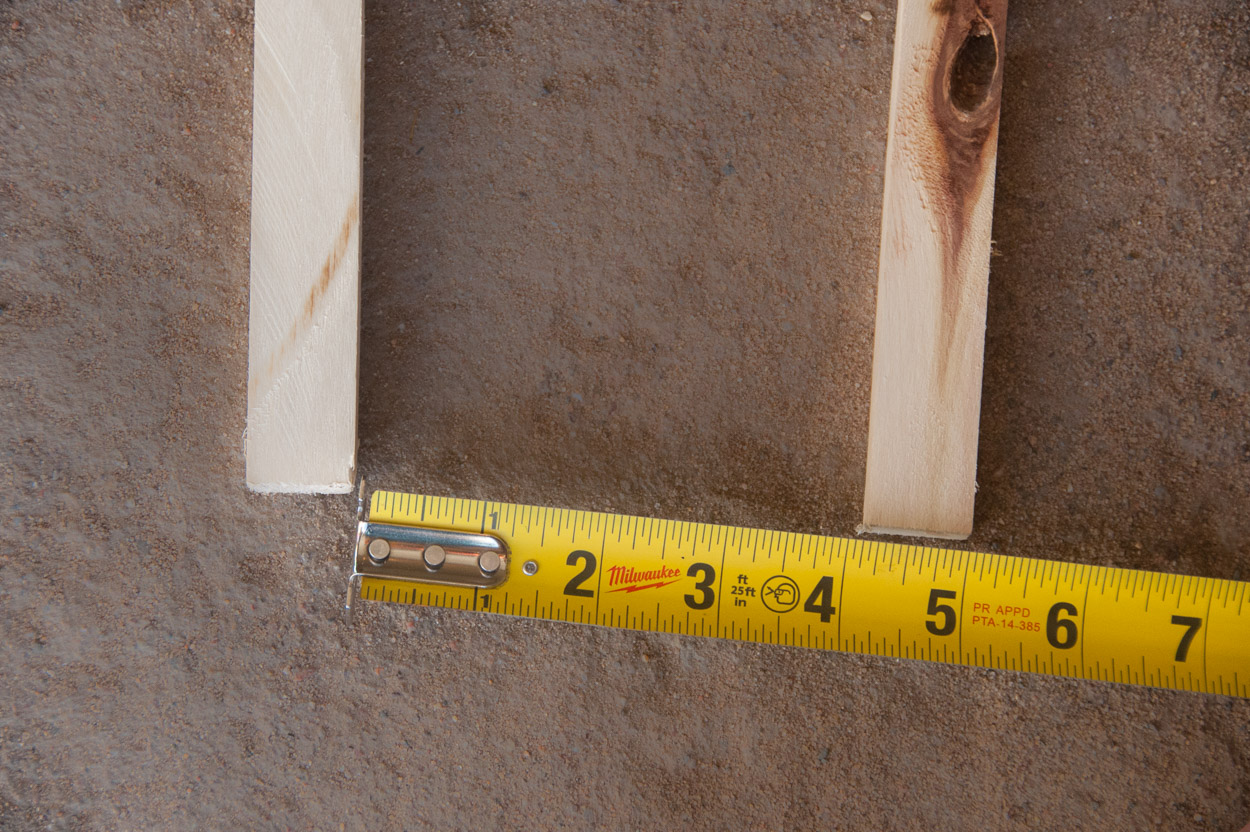 Spacing bottom of vertical sticks for a trellis.