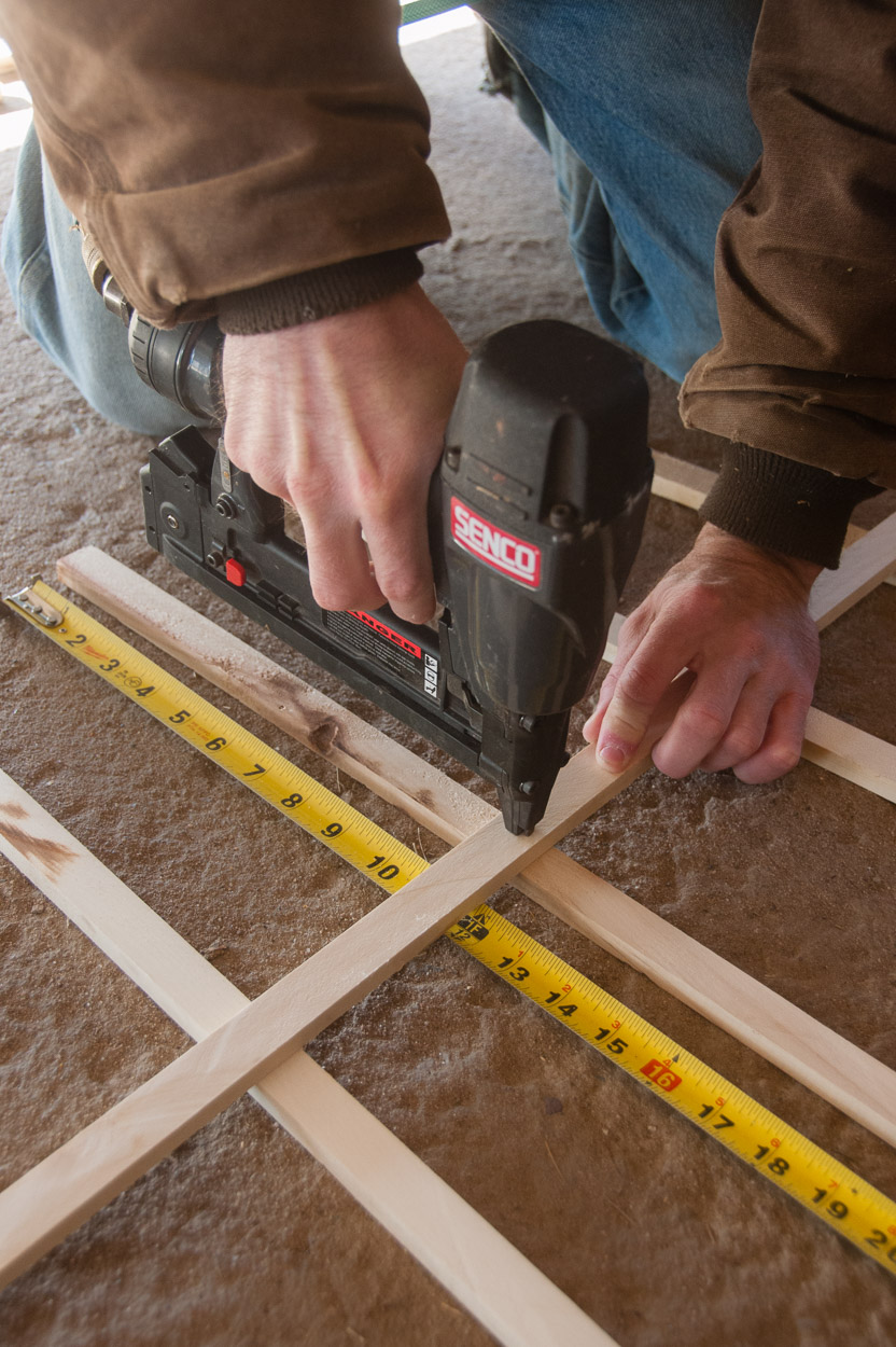Nailing wood junctions into place.